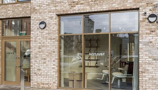 The shopfront, glass and pale brick