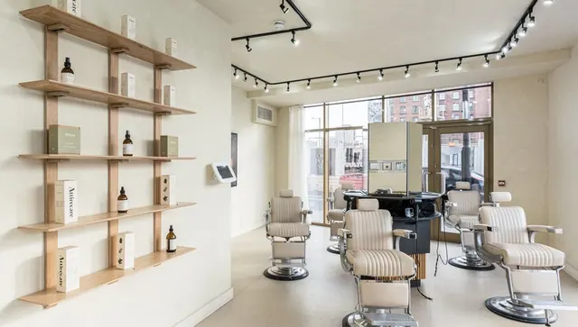 Inside: wooden shelves and three barber chairs